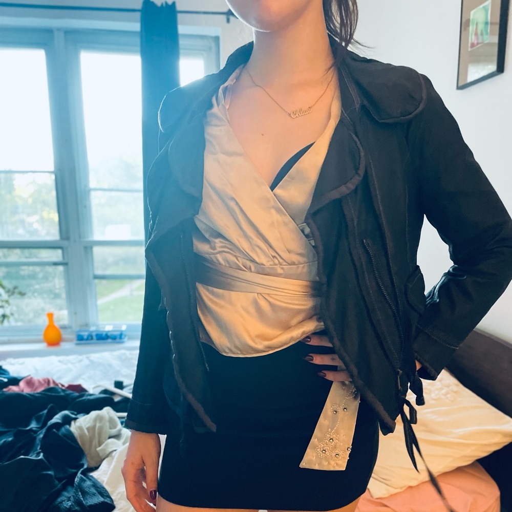 Hanii Y unique black leather jacket with some ruffles  It has 3/4 sleeves.